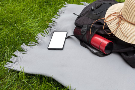 Picnic Setup with Backpack and Smartphone Mockupの写真素材