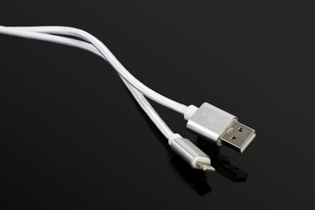Silver USB Charging Cable on Black Background