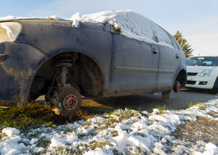 Abandoned Car on Blocks in Urban Areaの写真素材