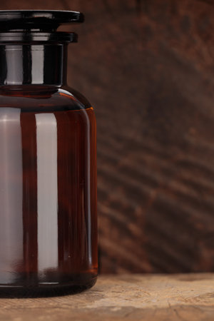 Vintage amber glass bottle on woodの写真素材