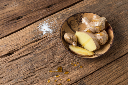Ginger and Honey healthy for asia herb ancient therapy cold on wood backgroundの写真素材