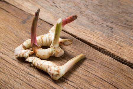 galangal on the wood texture Traditional thai food ingredient cuisineの写真素材