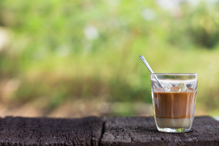 Hot drink thai milk tea signature local street beverage on wooden tableの写真素材