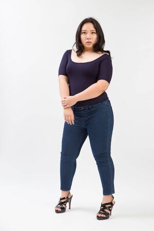 woman plus size standing on studio white backgroundの写真素材