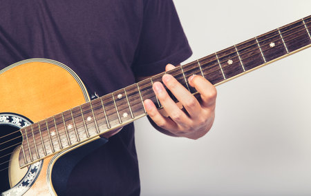 man play acustic guitar on white background close up shot