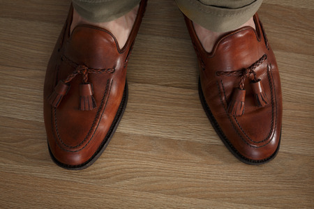 Preppy style dressed man wearing cushioned pants and loafersの写真素材