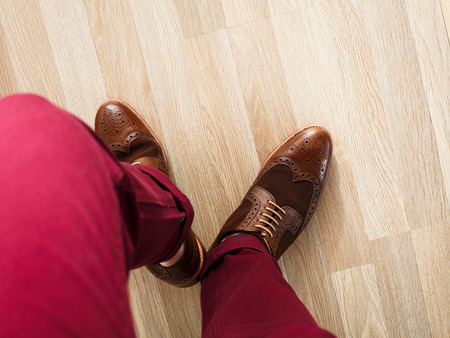 Stylish dressed man wearing cushioned pants and wingtipsの写真素材