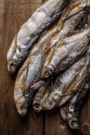 Dried fish on wooden table. Selective focus, narrow depth of field.の写真素材