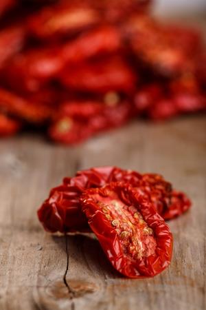 Sun dried tomatoes on wooden tableの写真素材