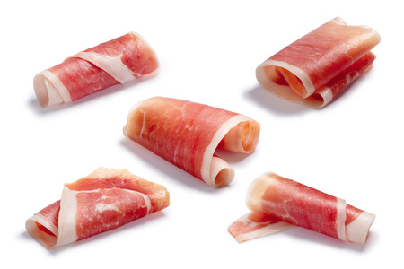 Jamon, Prosciutto, Speck, Dry Cured Meat or Ham slice, rolled up. Clipping paths for each, shadows separatedの写真素材