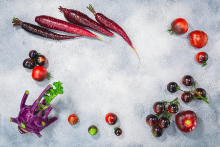 Anthocyanin-rich vegetables on light textured backdrop, top view