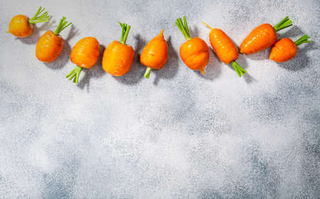 Short Rondo carrots on grey textured background with copy space, top viewの写真素材
