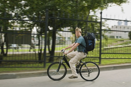 The man with a backpack goes on a bicycleの写真素材
