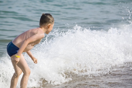 The boy has a fun in water on a beach
の写真素材
