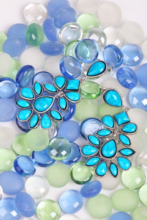 Earrings against color pebbles, costume jewelleryの写真素材