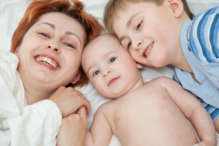 The happy woman with the baby and the eldest sonの写真素材