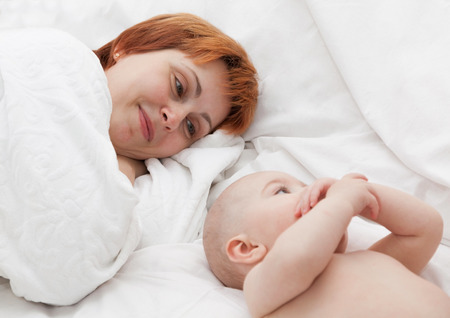 The happy woman with the baby at homeの写真素材