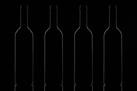 A number of wine bottles on a black backgroundの写真素材