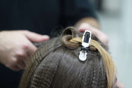 Shirring long hair in a hairdresser's shop is a frequently ordered procedure. As it helps the hair look more voluminousの写真素材