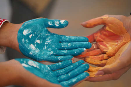 Drawing lessons at children's art school. Brushes, hands, paints. Children's palms in multi-colored paints.の写真素材