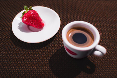 A Cup of coffee with some strawberry on different backgroundの写真素材