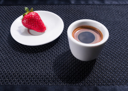 A Cup of coffee with some strawberry on different backgroundの写真素材