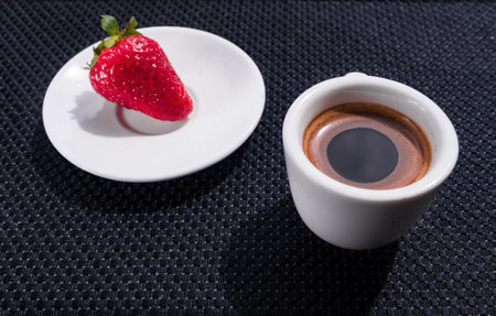 A Cup of coffee with some strawberry on different backgroundの写真素材