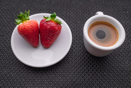 A Cup of coffee with some strawberry on different backgroundの写真素材
