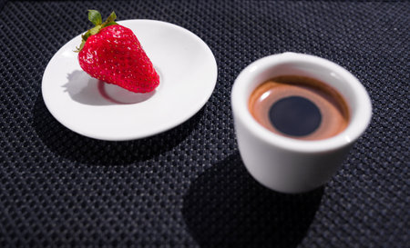 A Cup of coffee with some strawberry on different backgroundの写真素材