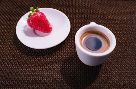 A Cup of coffee with some strawberry on different backgroundの写真素材