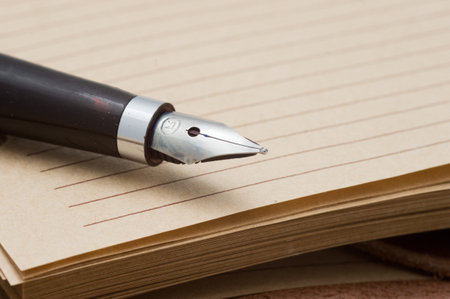 Old fountain pen on a notebook