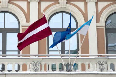 Latvian, EU and Riga flags on the faÐ¡Ðade of city government buildingの写真素材