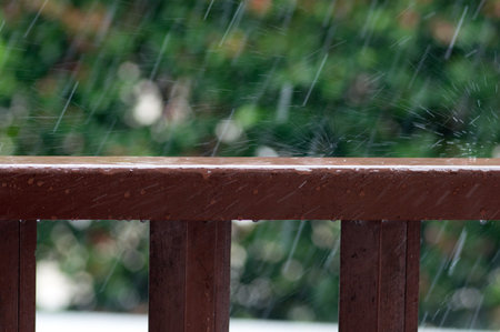 Rain drops on wooden railing