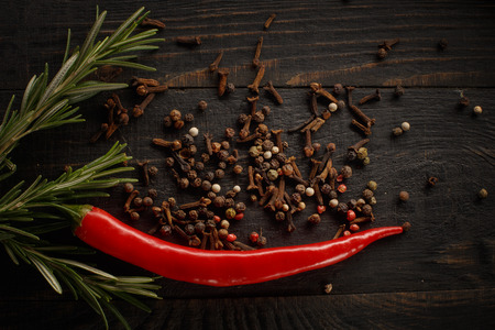 Spices and herbs on the black wood background.の写真素材