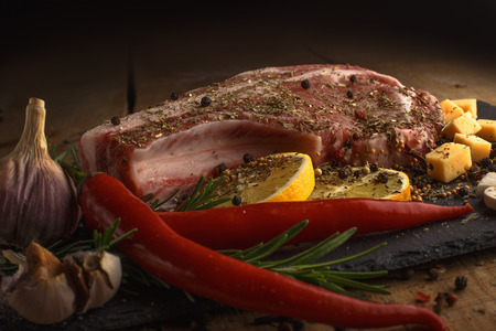 Fresh meat with ingredients for cooking on wood background.の写真素材