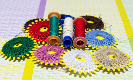 Spools of colored cotton thread used to sewの写真素材