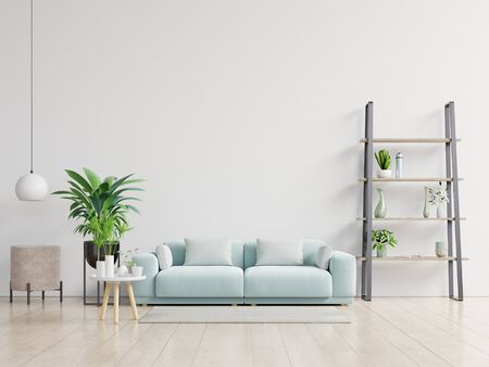 Empty living room with blue sofa, plants and table on empty white wall background. 3D renderingの写真素材