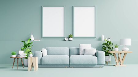 Interior poster mockup with vertical empty wooden frame standing on wooden floor with sofa and cabinet.3D renderingの写真素材
