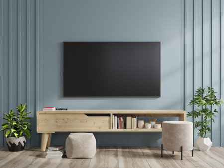 TV on the cabinet in modern living room on dark blue wall background,3d rendering