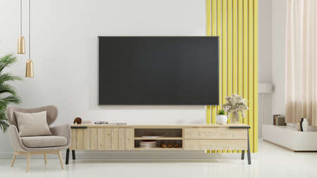 TV on cabinet in modern living room with armchair,lamp,table,flower and plant on white wall background,3d renderingの写真素材