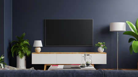 Mockup tv on cabinet in modern empty room with behind the dark blue wall.3d renderingの写真素材