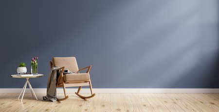 Living room interior mockup in warm tones with brown armchair on empty dark blue wall background.3d renderingの写真素材