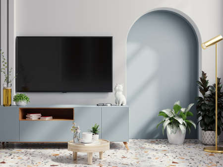TV on blue cabinet in an empty living room interior with white wall.3D renderingの写真素材