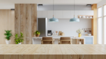 Wooden table top on blur kitchen room background,Modern Contemporary kitchen room interior.3d renderingの写真素材