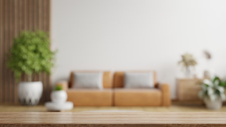 Wood table top on blur living room have leather sofa and decoration minimal.3d renderingの写真素材