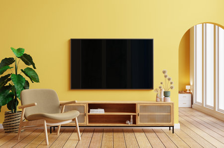 Mockup TV in modern living room with armchair and plant on yellow wall- 3D renderingの写真素材