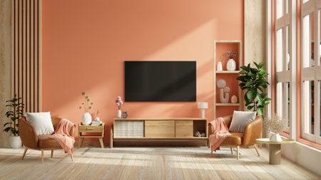 Mockup a TV wall mounted with leather armchair in pastel tone peach fuzz color wall- 3D renderingの写真素材