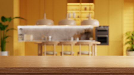 Wooden table top on blur kitchen room background,yellow kitchen room- 3D renderingの写真素材