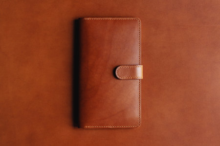 Brown leather wallet on a brown background. for your logo.の写真素材