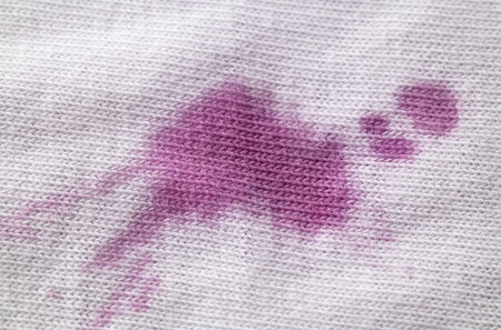Wine stain on white clothes macro. Close-up cotton textureの写真素材